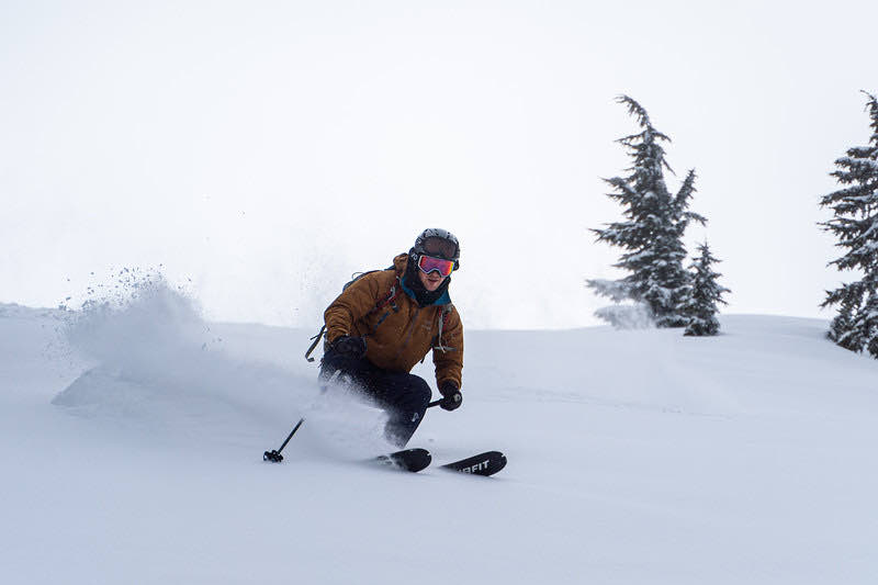 A skier turning through deep powder